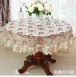Elegant lace tablecloth with rose gold embroidery on a dining table