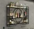 Black wall mounted wine rack with wine bottles and glasses on display