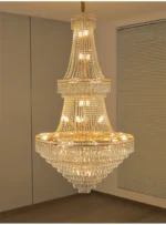 Modern crystal chandelier for dining room hanging over a wooden table with warm glow
