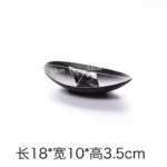 Black melamine dinner plates stacked elegantly on a wooden table