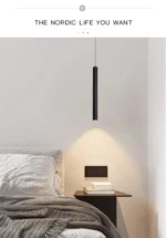 Modern pendant light with double cylindrical shades in a Nordic dining room setting