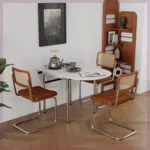 Nordic minimalist folding dining table with stainless steel telescopic extension in a modern living room setting