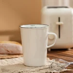 Enamel baking measuring cup with dual scale markings on a kitchen counter