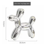 Gold balloon dog saving pot on a windowsill with sunlight highlighting its shine.