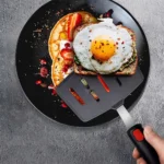 Goldoma high heat resistant spatula in use on a non-stick frying pan