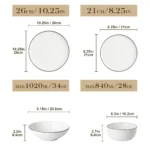 Elegant ceramic plates set with dinner plates, dessert plates, cereal bowls, and soup bowls arranged on a wooden table