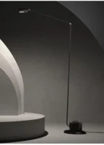 Italian design floor lamp in black, photographed from above to show the circular shade and base.