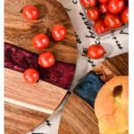 Round acacia cutting board with resin inlay on kitchen counter