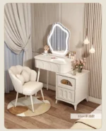 Modern wood makeup vanity table with mirror, drawer, and stool in a bedroom setting