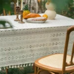 Retro polka dot tablecloth with fringe on a wooden table