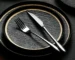Black dinner plate with quicksand texture on a wooden table