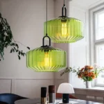 Modern colored glass pendant lamp illuminating a cozy dining room with vibrant hues