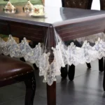 Elegant waterproof table protector with lace embroidery on a rectangular dining table