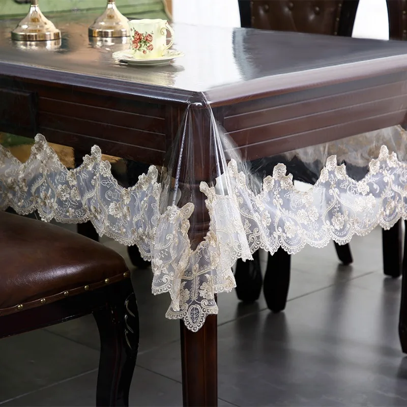 S8e61700b37f4495a9b9ce22f8bbfda9a5.webp Elegant waterproof table protector with lace embroidery on a rectangular dining table