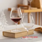 Kimura Shouko ultra thin wine glass on a wooden table, catching light