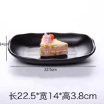 Black melamine dinner plates stacked elegantly on a wooden table