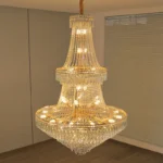 Modern crystal chandelier for dining room hanging over a wooden table with warm glow