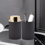 Close-up of the pump mechanism on a white foam soap dispenser, highlighting its brushed nickel finish.