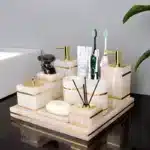 Marble bathroom set on white sink, reflection.