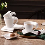 White porcelain espresso cup with wavy design on saucer, modern home decor