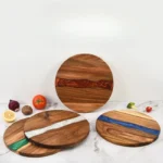 Round acacia cutting board with resin inlay on kitchen counter