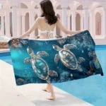 Sea turtle beach towel with vibrant underwater pattern on a sandy beach