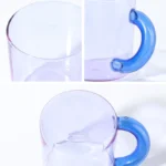 Borosilicate glass mug with coffee and glass spoon on a wooden table