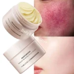 Facial redness repair cream in a white tube with red accents, on a clean bathroom counter.