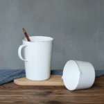 Enamel baking measuring cup with dual scale markings on a kitchen counter