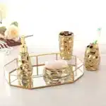 Goldoma golden ceramic soap dispenser with elegant pump, side view on wooden tray.