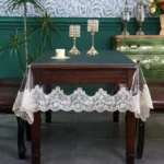 Elegant waterproof table protector with lace embroidery on a rectangular dining table