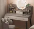 Modern white LED makeup vanity table with mirror and stool in a well-lit bedroom