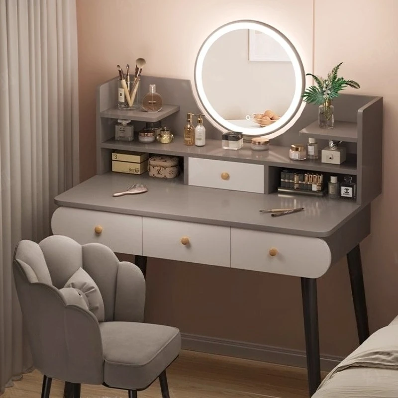 Modern white LED makeup vanity table with mirror and stool in a well-lit bedroom