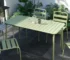 Metal patio dining table with chairs on a deck