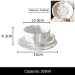 Pink cherry blossom mug with saucer on a dining table