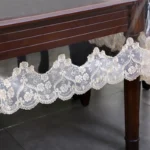 Elegant waterproof table protector with lace embroidery on a rectangular dining table