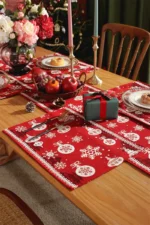 Red and green Christmas table runner with plaid pattern on dining table