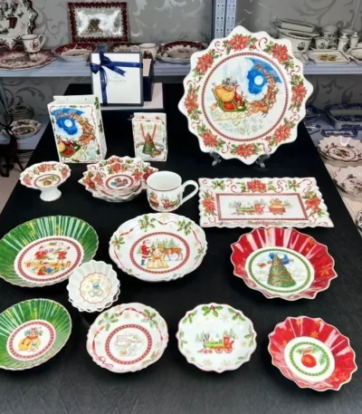 Christmas dinner plates with festive holly and berry pattern on a wooden table