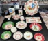 Christmas dinner plates with festive holly and berry pattern on a wooden table