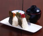 Japanese style ramen bowl set with melamine bowls, spoons, and noodle cups on a table