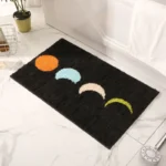 Modern abstract art non slip bathroom rug with vibrant colors and textured surface on a bathroom floor