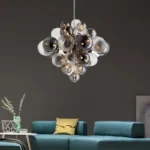 Smoky gray chandelier with glass bubbles hanging over a modern dining table