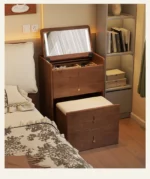 Wooden makeup vanity with mirror and stool in a modern bedroom setting