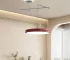 Modern pendant light hanging over a dining island with warm glow