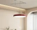 Modern pendant light hanging over a dining island with warm glow