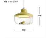 Mordern hanging light with clear glass and brass accents, illuminating a kitchen island