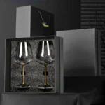 Elegant crystal wine glass set on a wooden table with soft lighting
