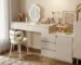 White oak vanity table with mirror and stool in a bright bedroom setting