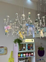 Modern stainless steel chandelier with crystal LED lights in a living room