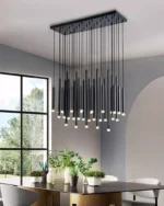 Clear glass globe pendant light on adjustable cord in a stairwell.